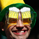 Man smiling wearing glasses shaped to look like beer goggles